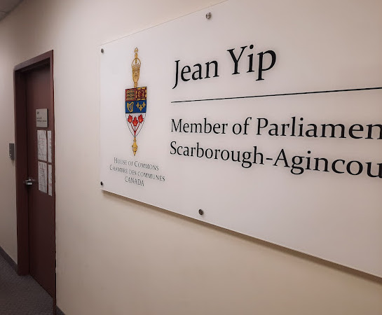 Sign on a wall that says: Jean Yip, Member of Parliament Scarborough Agincourt.