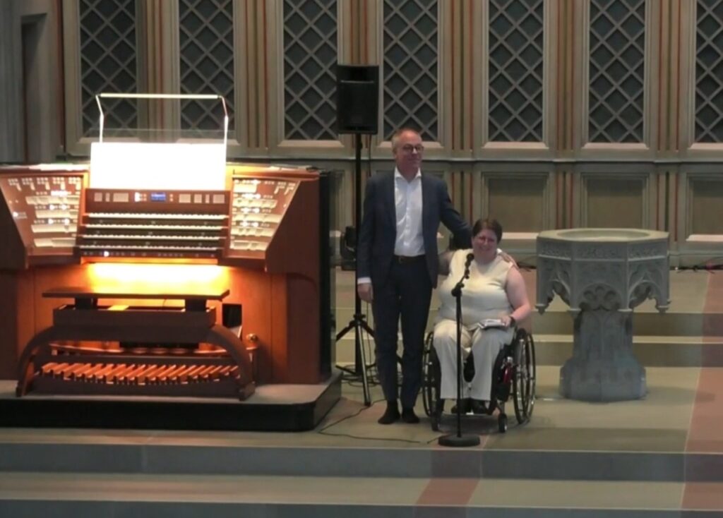 Bernhard Ruchti the organist and Diane the singer salute after a concert. The organ console is on the left.