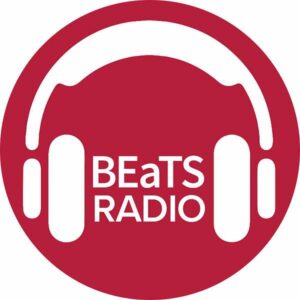 A red circular logo containing white headphones and the name of the show, BEaTS Radio.